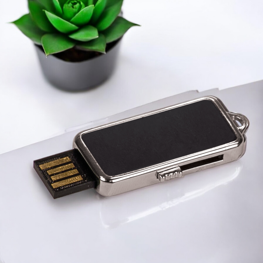 Custom 8GB metal USB flash drive with keychain, laser engraved for corporate branding and promotional products in sleek black and silver design.