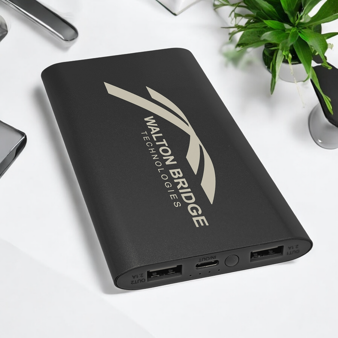 Black 8000mAh anodized aluminum power bank and wireless charger with USB-C cord, compatible with wireless and USB-powered devices.