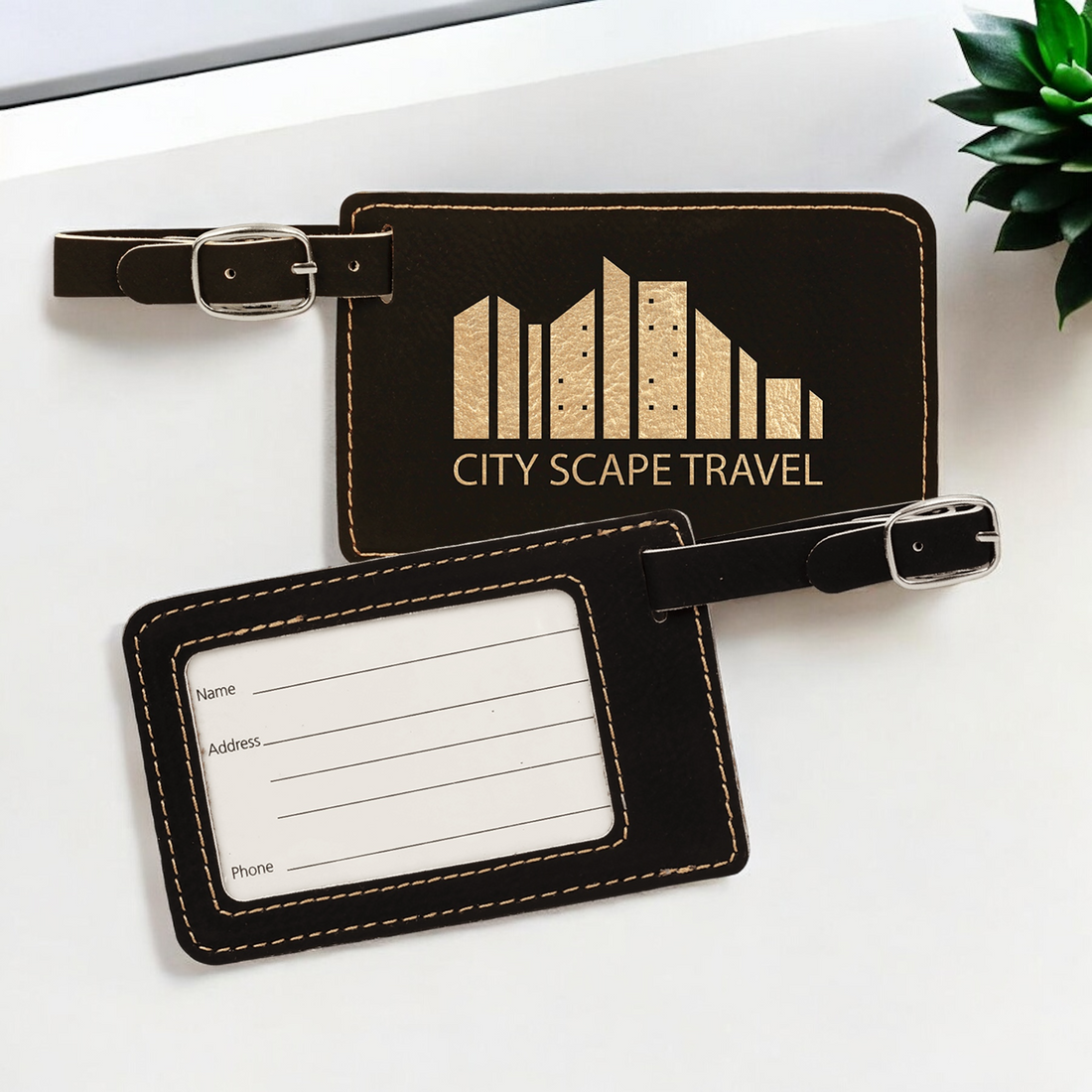 Custom laser-engraved leatherette luggage tags with silver buckle straps and removable inserts for Name, Address, and Phone, ideal for corporate branding and travel gifts."