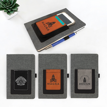 Custom laser-engraved leatherette journal with elastic phone holder, card slot, and pen loop, ideal for corporate branding, promotional giveaways, and professional gifts.