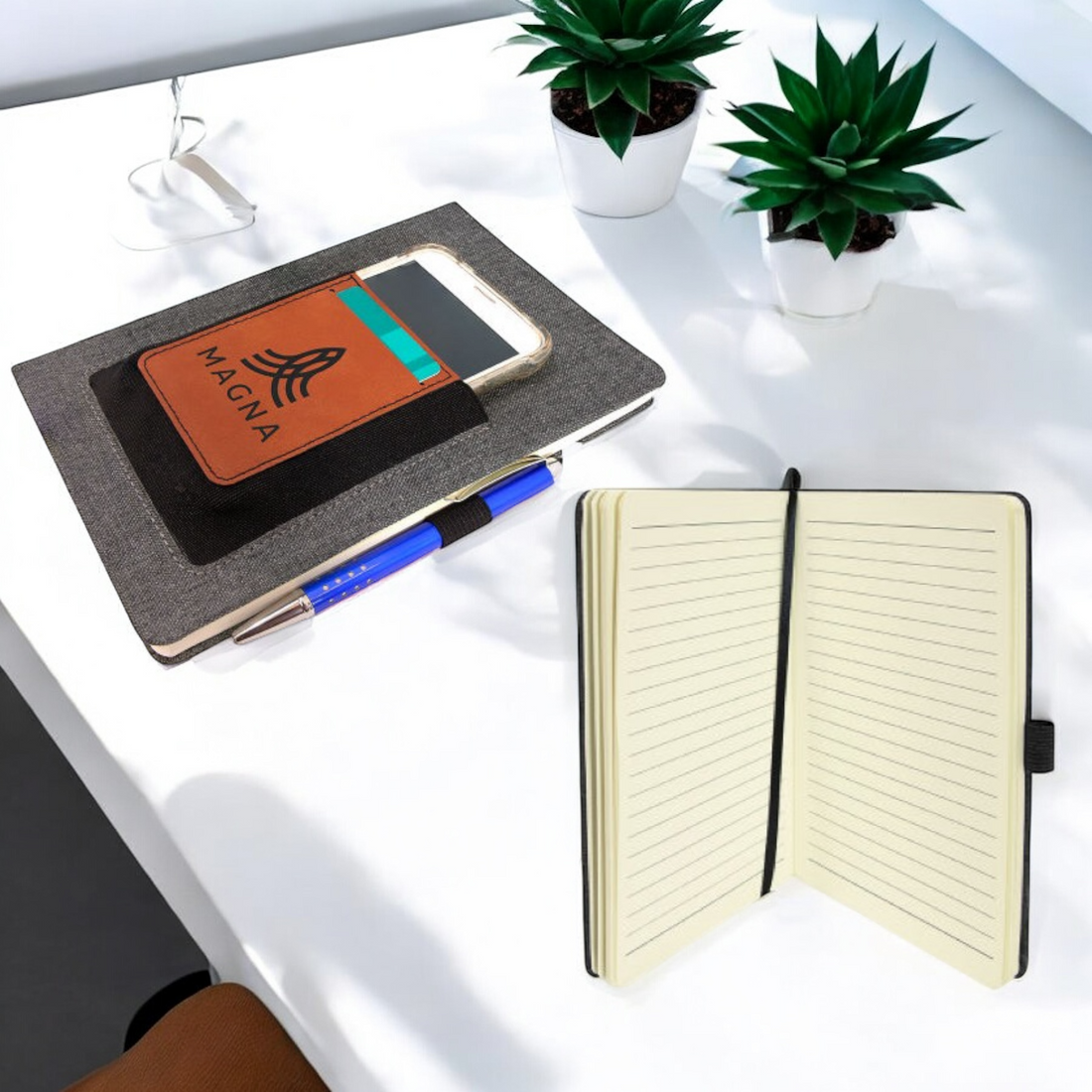 Custom laser-engraved leatherette journal with elastic phone holder, card slot, and pen loop, ideal for corporate branding, promotional giveaways, and professional gifts.