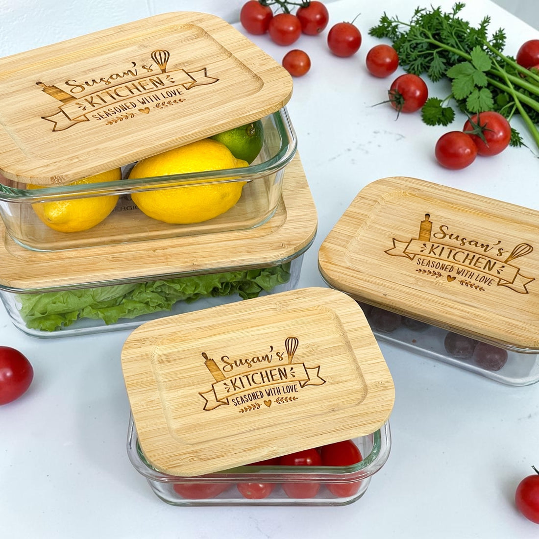 Luxury personalized glass storage container set with engraved bamboo lids featuring custom kitchen design and family-inspired engraving. Eco-friendly reusable meal prep and kitchen organization containers styled with fresh produce for realtor closing gifts, new homeowner gifts, and modern farmhouse kitchen décor.