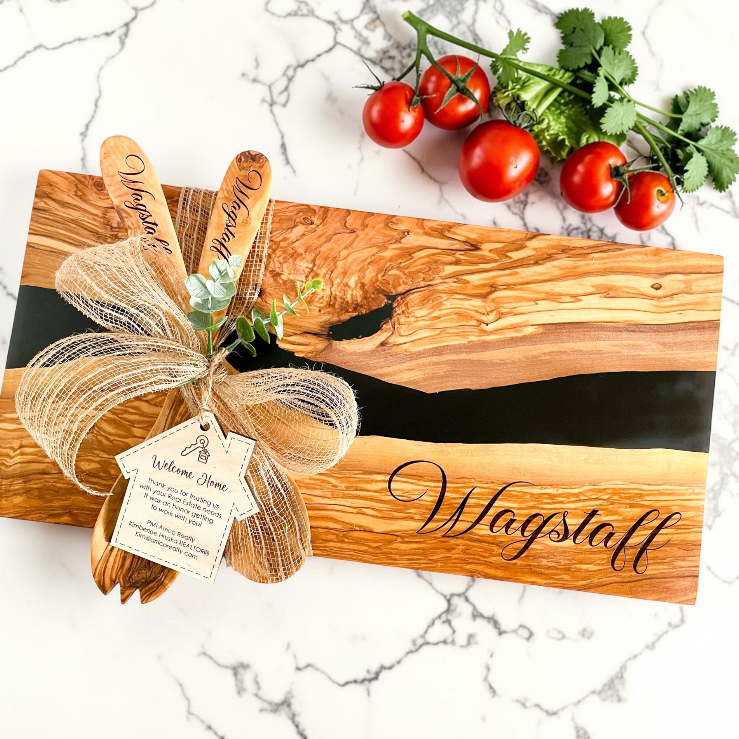 Modern personalized olive wood and black resin charcuterie board for realtor closing gifts and luxury kitchen gifting styled on bright kitchen countertop