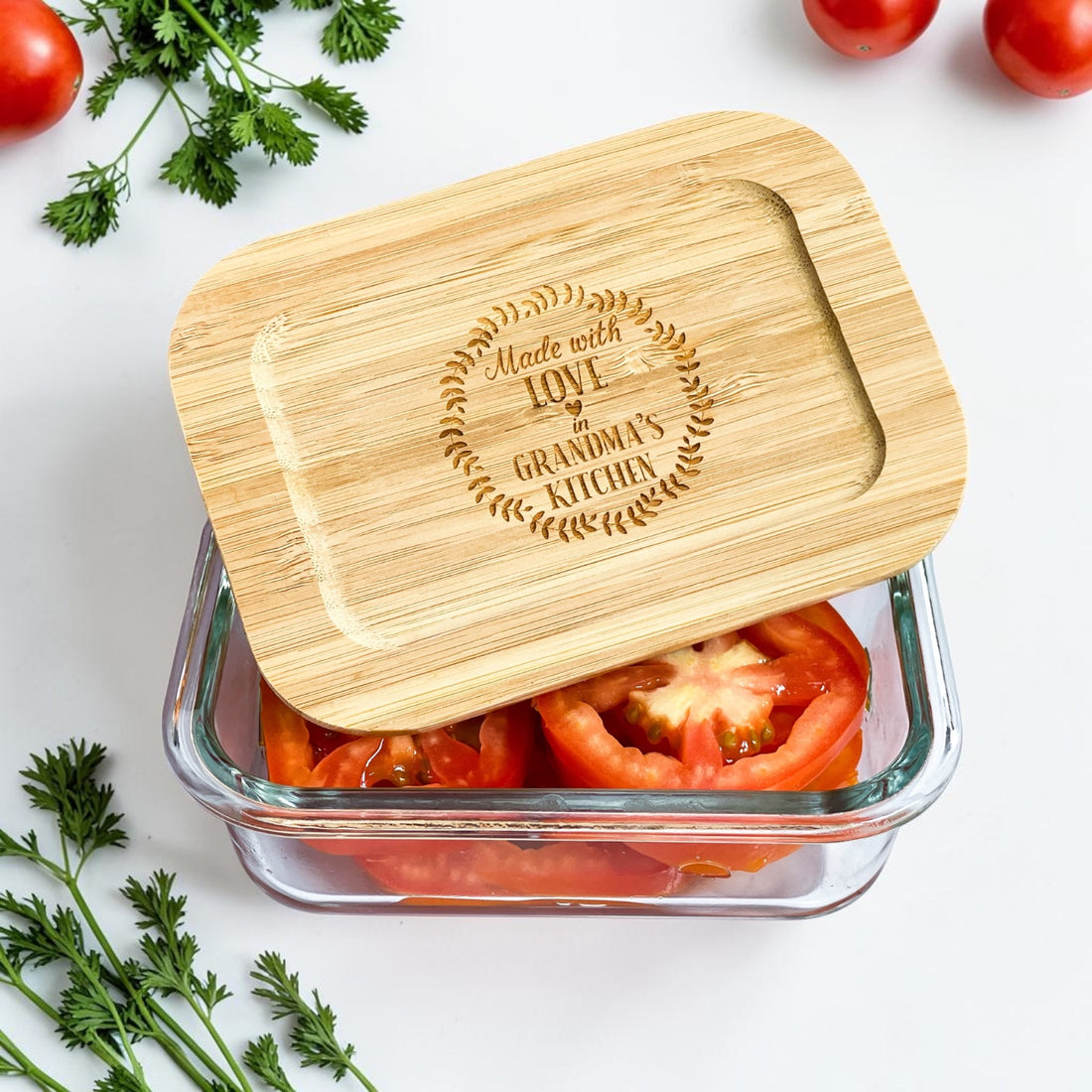 Personalized glass food storage container set with engraved bamboo lids styled with fresh vegetables in a modern kitchen setting. Eco-friendly kitchen organization containers designed for realtor closing gifts, luxury housewarming gifts, and new homeowner gift baskets.