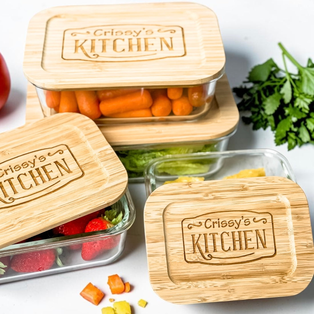 Luxury personalized glass food storage containers with engraved bamboo lids displayed with fresh produce in a modern kitchen-inspired setting. Elegant realtor closing gift and custom housewarming gift designed for sustainable kitchen organization, meal prep, elevated everyday living, and thoughtful gifts homeowners will use daily.