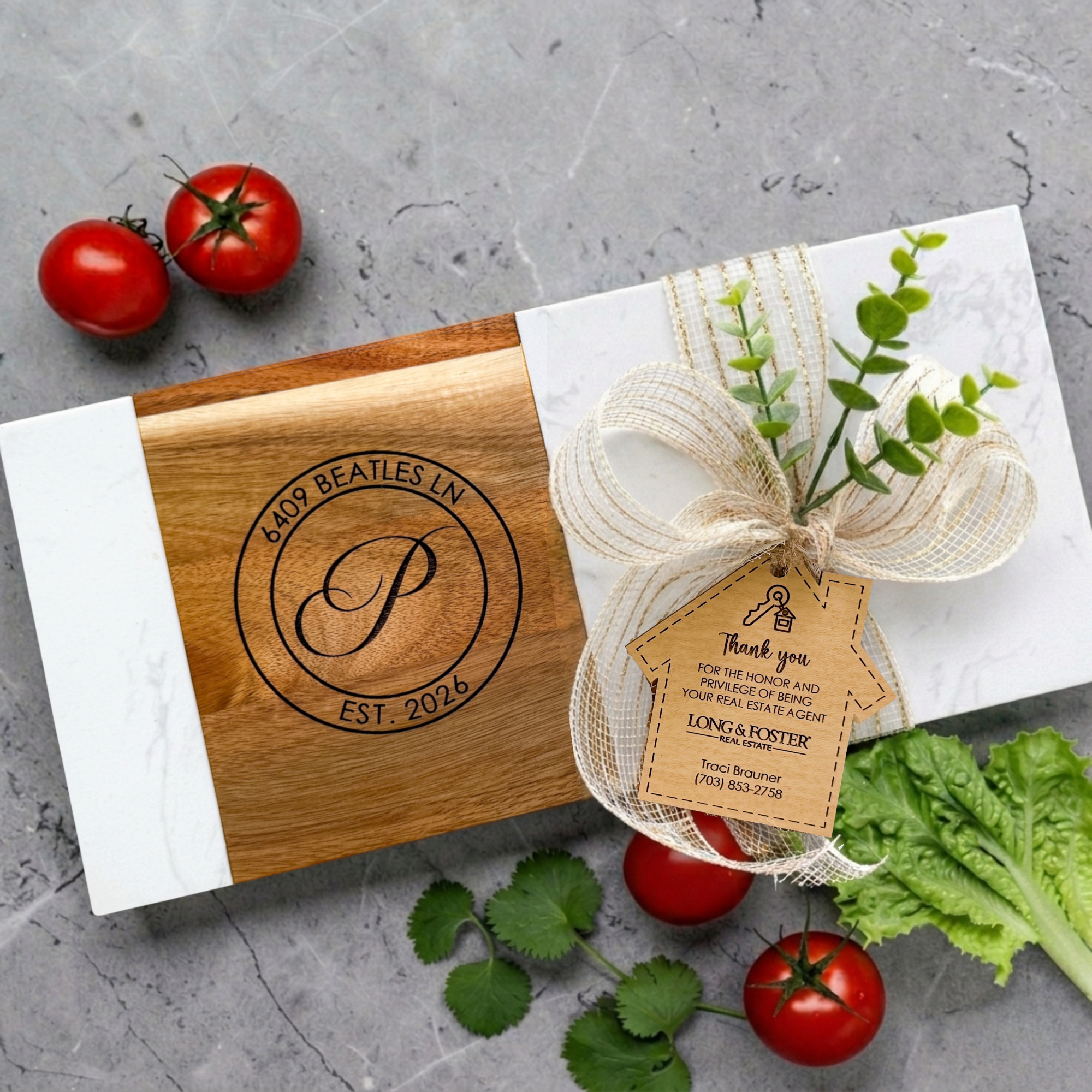 Luxury marble and acacia wood charcuterie board engraved with monogram, address, and established date styled with elegant ribbon, realtor thank you gift tag, and fresh vegetables for realtor closing gifts and new homeowners