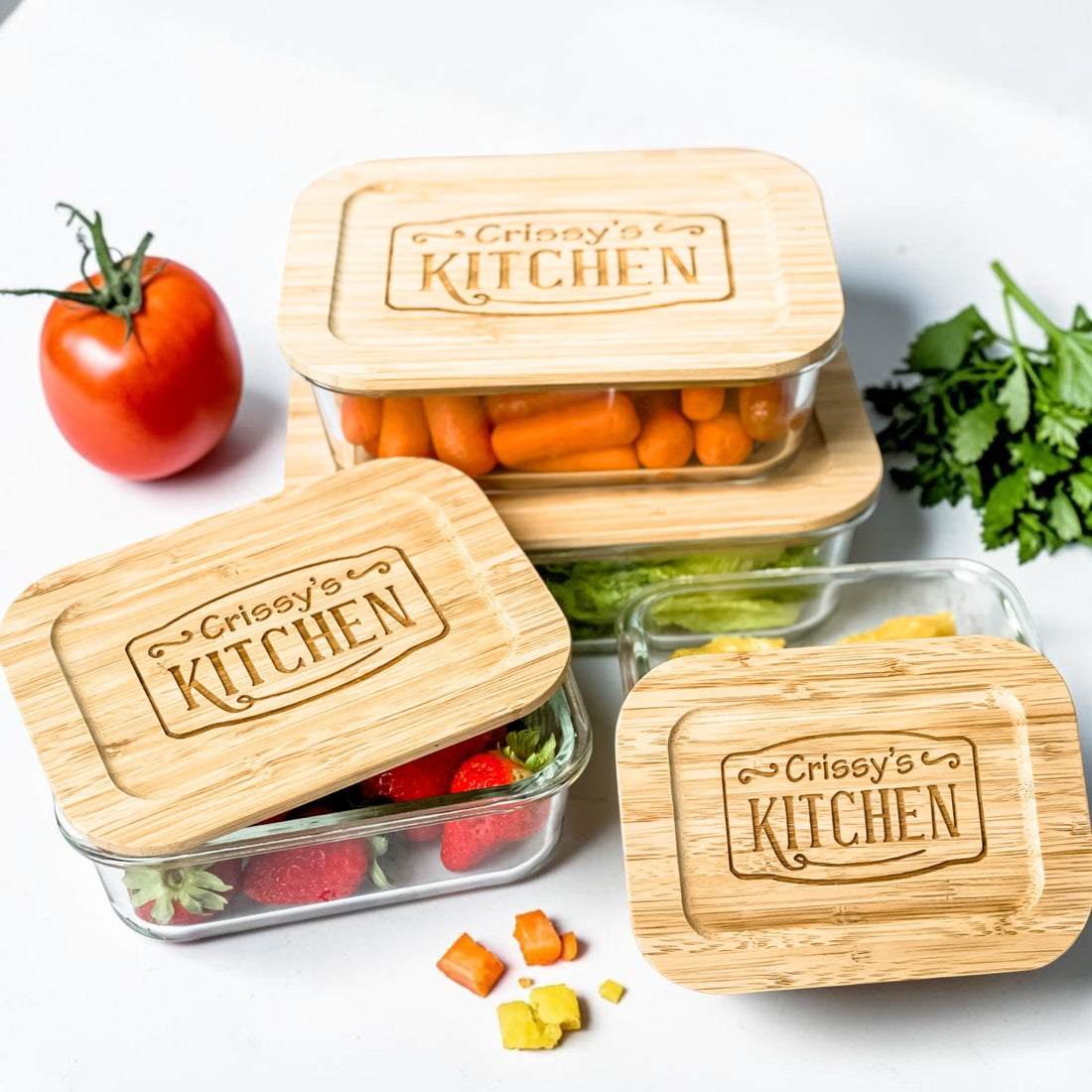 Luxury personalized glass food storage containers with engraved bamboo lids displayed with fresh produce in a modern kitchen-inspired setting. Elegant realtor closing gift and custom housewarming gift designed for sustainable kitchen organization, meal prep, elevated everyday living, and thoughtful gifts homeowners will use daily.
