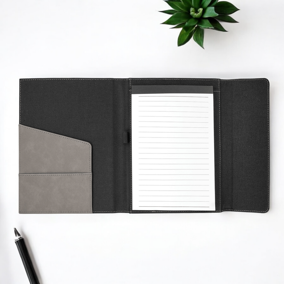 Custom laser-engraved leatherette and gray canvas portfolio with 50-page lined notepad, magnetic closure, and engraving areas for corporate branding or personalized gifts.