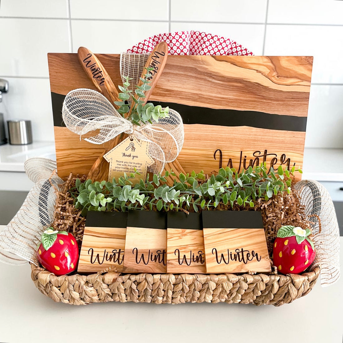 Luxury personalized black river resin and olive wood cutting board gift basket for realtors, home buyers, and housewarming gifts. Includes engraved coasters and personalized serving spoons.