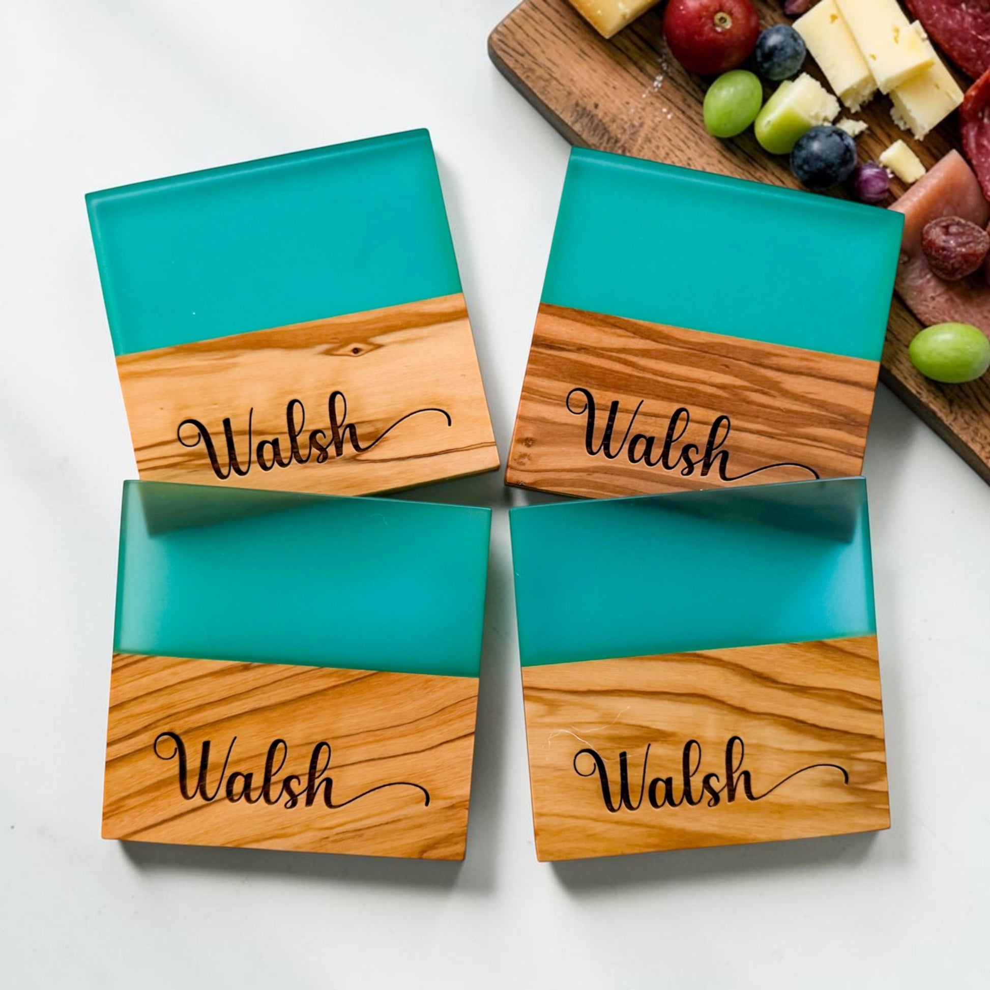 Personalized blue river resin and olive wood coaster set with engraved family name styled as a luxury realtor closing gift and modern housewarming kitchen accessory