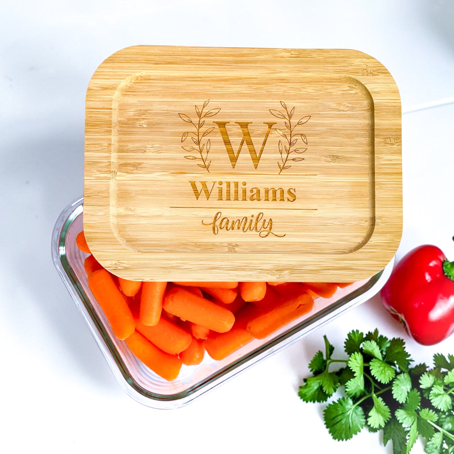 Personalized glass food storage container with engraved bamboo lid featuring custom monogram and family name. Elegant realtor closing gift and luxury housewarming gift for new homeowners, kitchen organization, meal prep, sustainable food storage, and personalized client appreciation gifts.