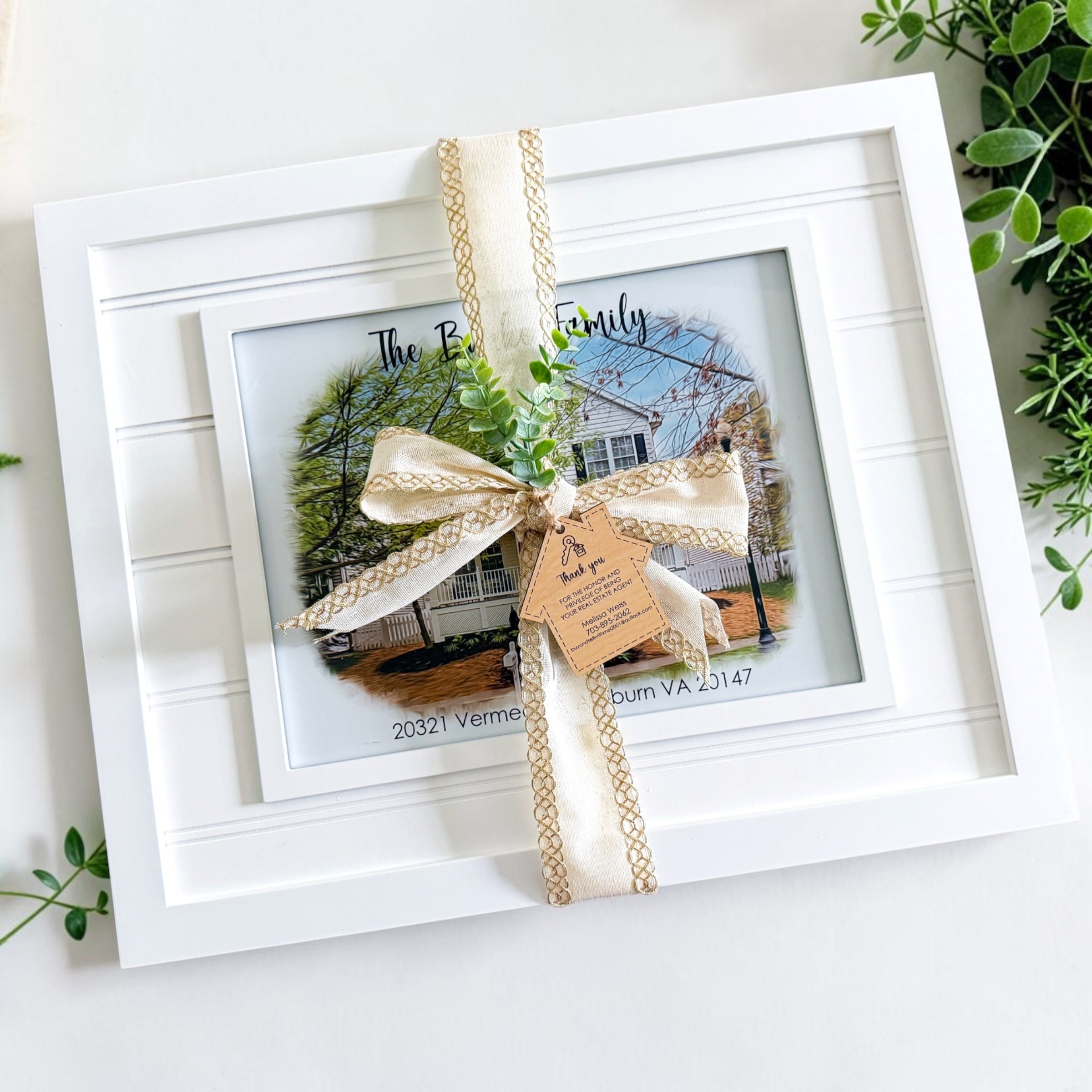 Personalized framed house portrait gift wrapped with neutral ribbon and realtor thank you gift tag as a luxury housewarming gift and realtor client appreciation gift