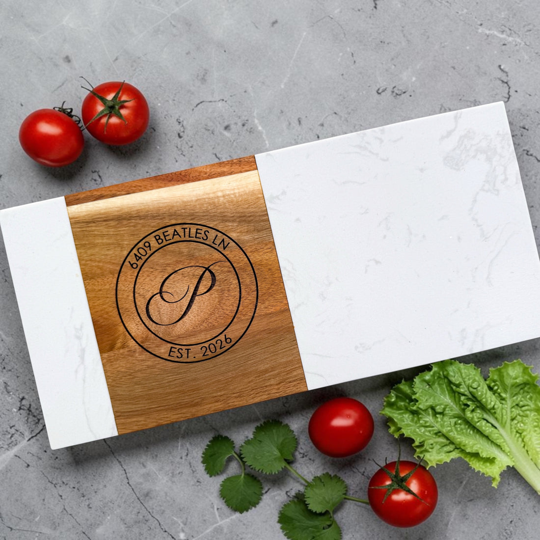 Modern personalized marble and acacia wood charcuterie board engraved with monogram, address, and established date styled on neutral kitchen background for realtor closing gifts and new homeowners