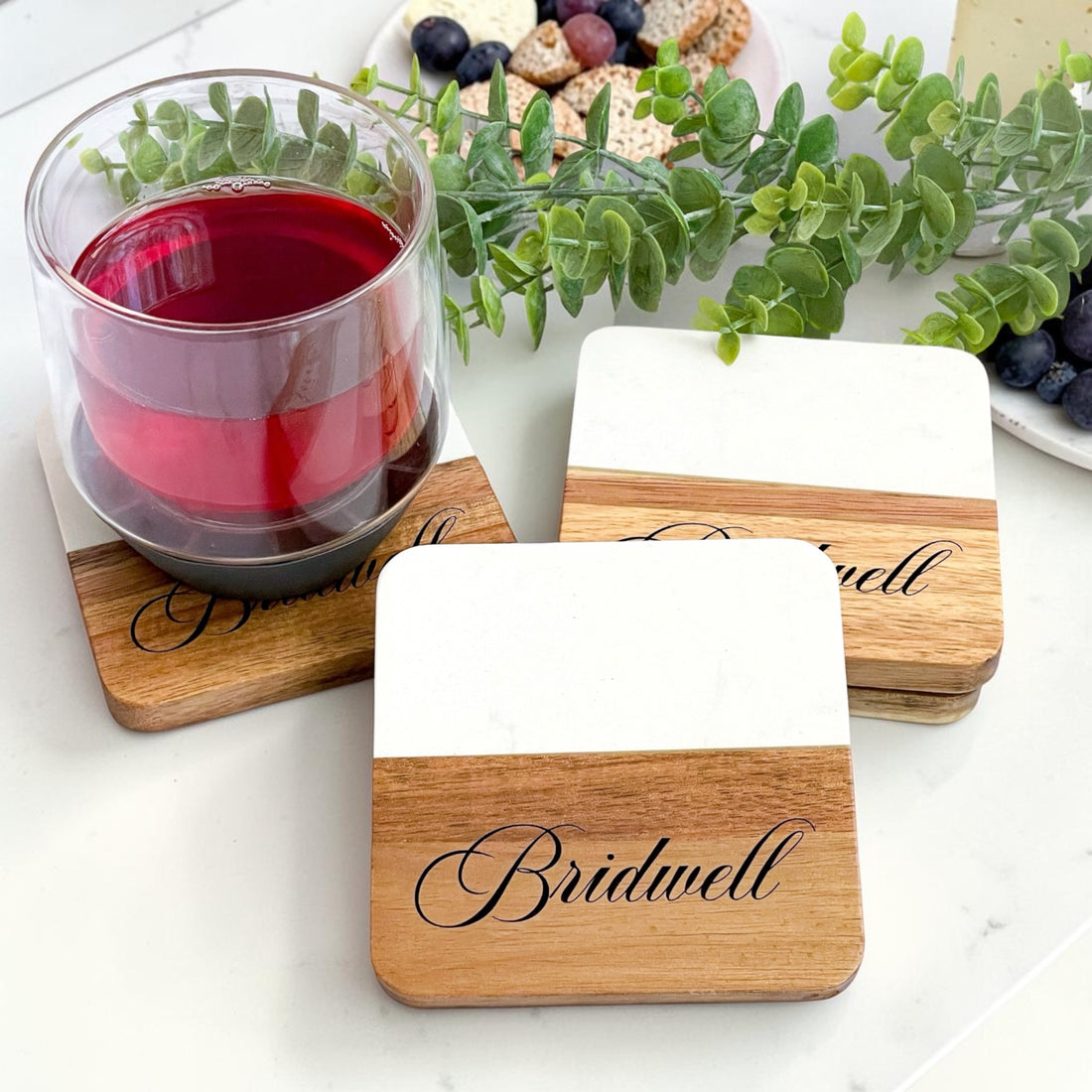 Luxury personalized housewarming and realtor closing gift basket with marble and acacia wood serving board, engraved olive wood utensils and custom coasters