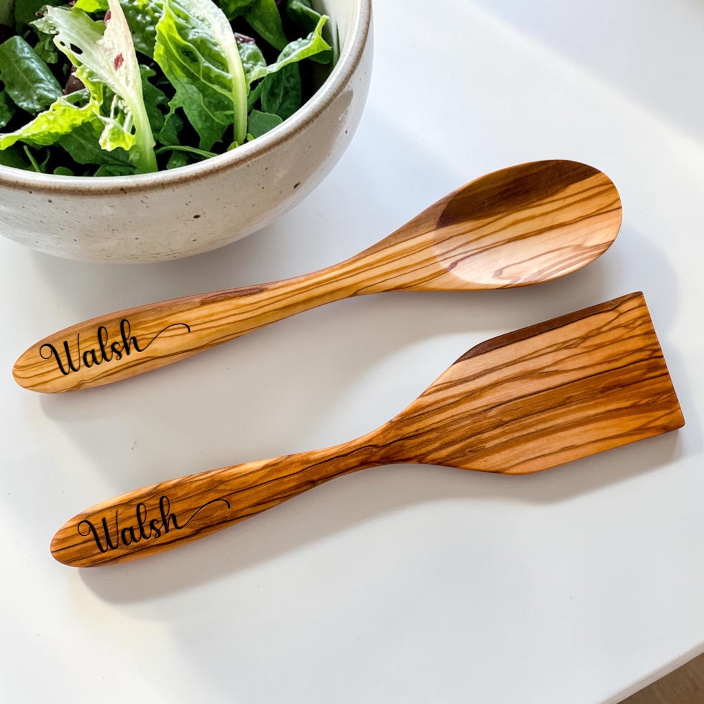 Personalized olive wood serving spoon and spatula engraved with family name styled as luxury kitchen accessories for realtor closing gifts and upscale housewarming presents