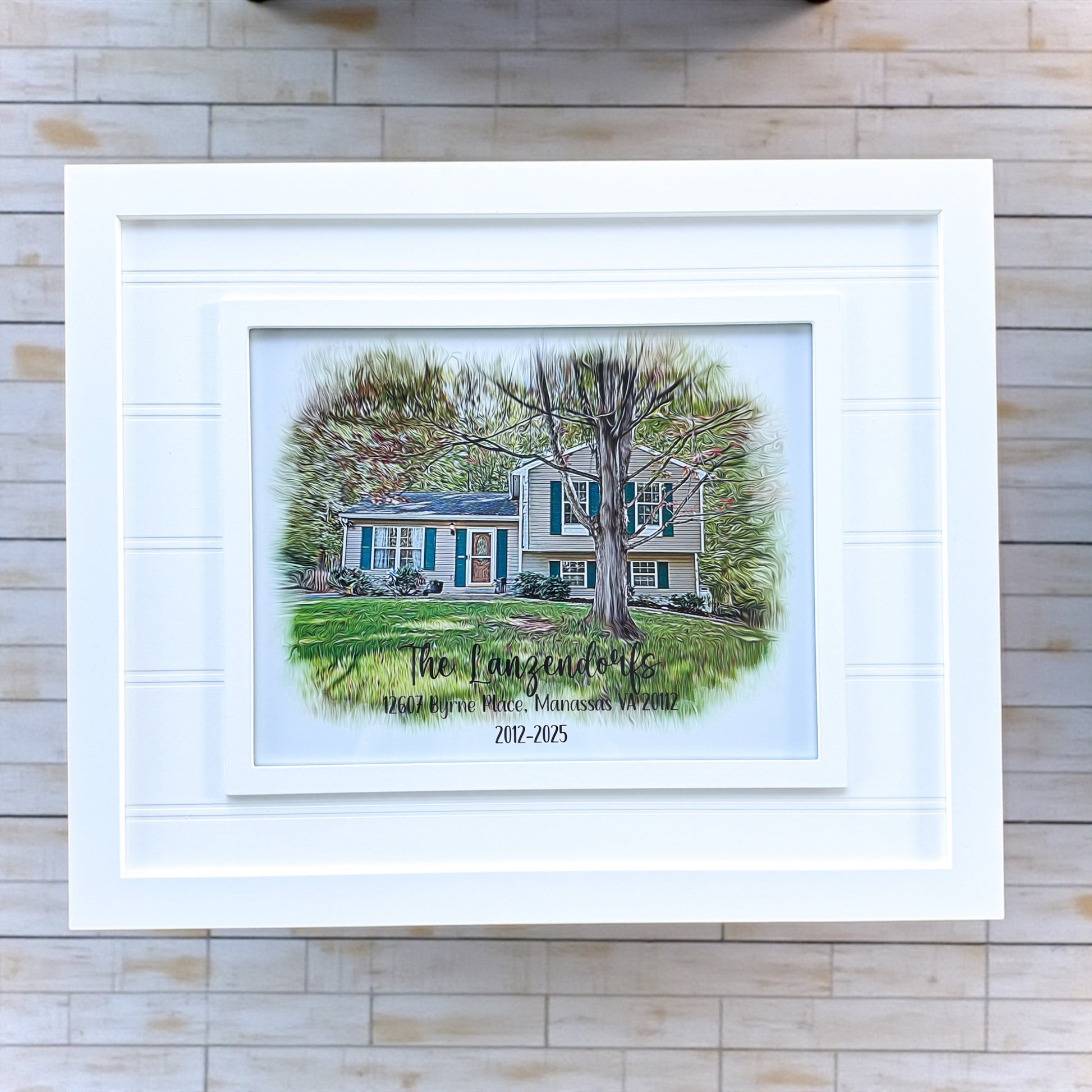 Custom framed digital oil painting style house portrait personalized with family name and address displayed in white beadboard frame for realtor closing gifts and housewarming gifts